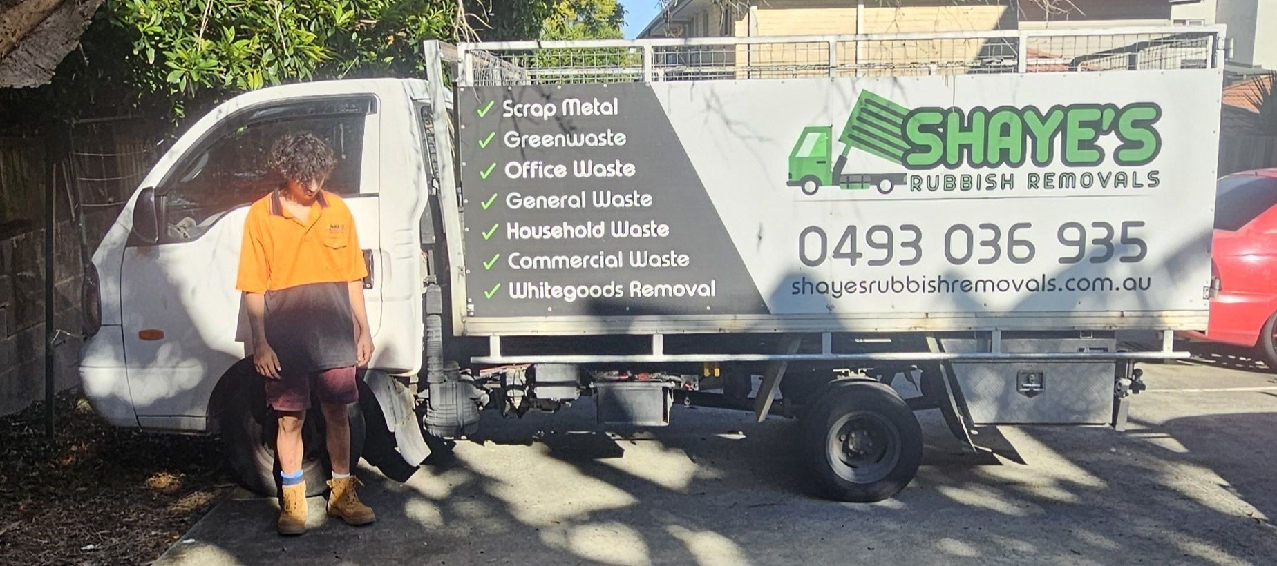 Shayes Rubbish Removals Truck with person standing infront of it.