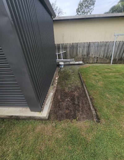 After timber beams have been removed from next to backyard shed.