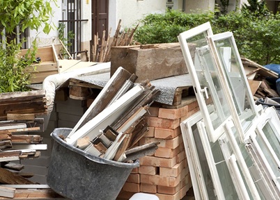 An assortment of construction rubbish outside a Brisbane home. Window frames, timber and bricks.