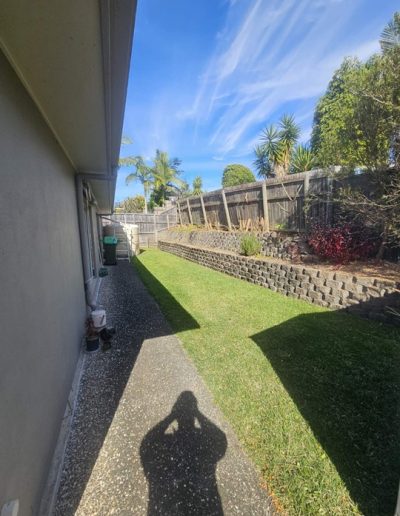 Side of a home in Logan (Brisbane) after Shaye's removed garden rubbish.